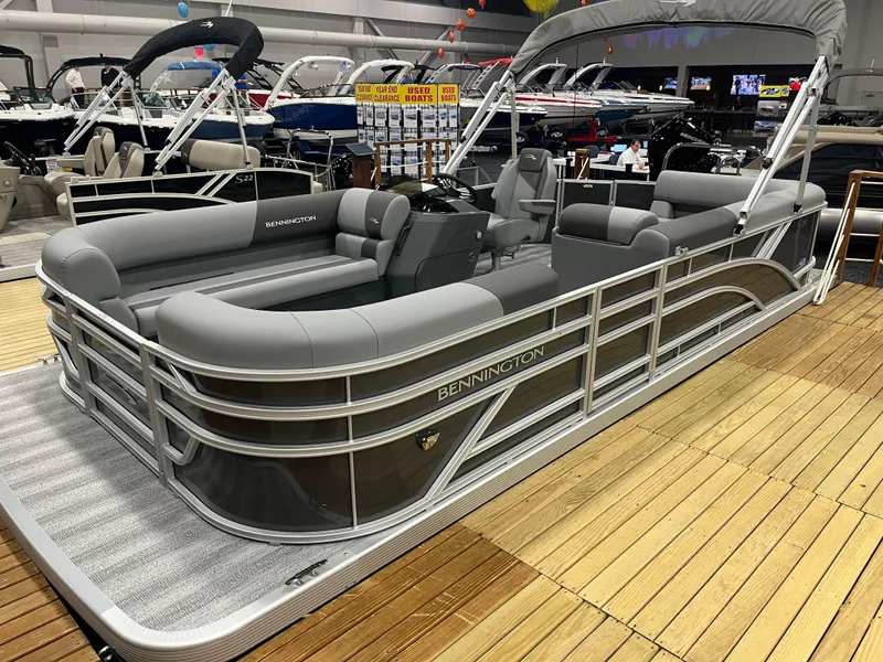 Slide: The Image of 2025 Bennington S Line pontoon boat displayed indoors on wooden flooring. - 11