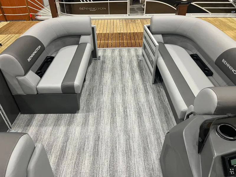 Slide: The Image of 2025 Bennington S Line boat interior with gray seating and carpet flooring. - 4