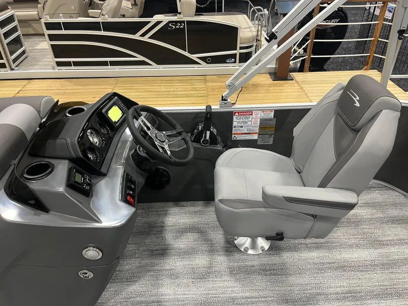 Slide: The Image of 2025 Bennington S Line boat interior with steering console and captain's chair. - 7