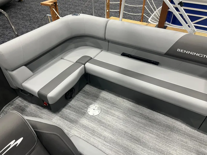 Slide: The Image of 2025 Bennington S Line boat interior with gray seating and carpeted flooring. - 9