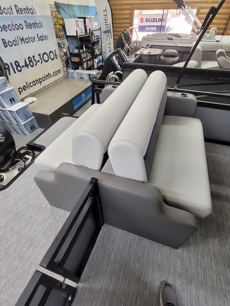 Slide: The Image of 2025 Quest 22 LE boat interior with gray seating and showroom display. - 10