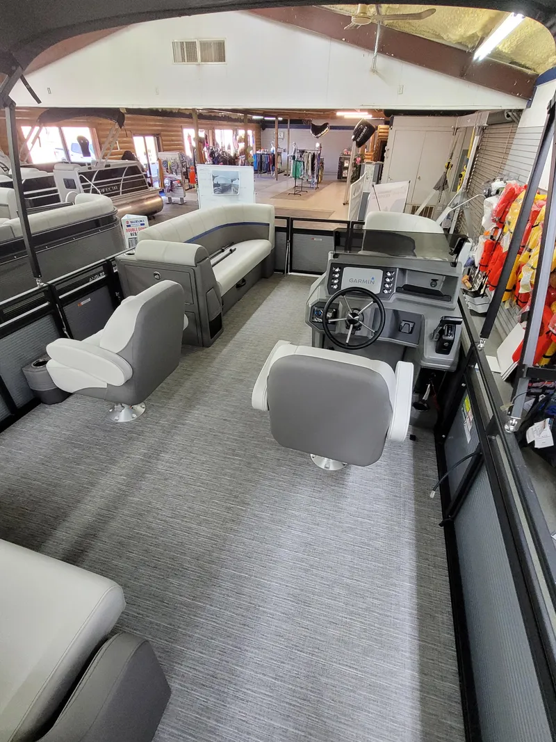 Slide: The Image of 2025 Quest 22 LE pontoon boat interior with modern seating and steering console. - 12