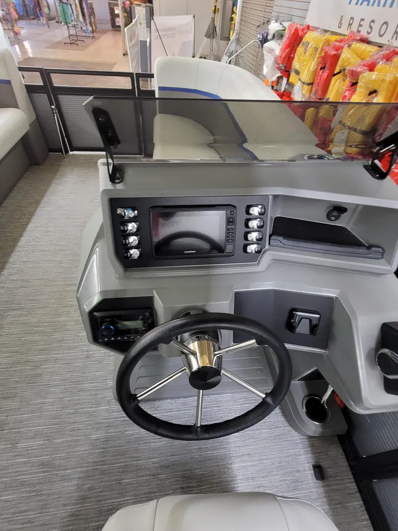 Slide: The Image of 2025 Quest 22 LE boat dashboard with steering wheel and control panel. - 13