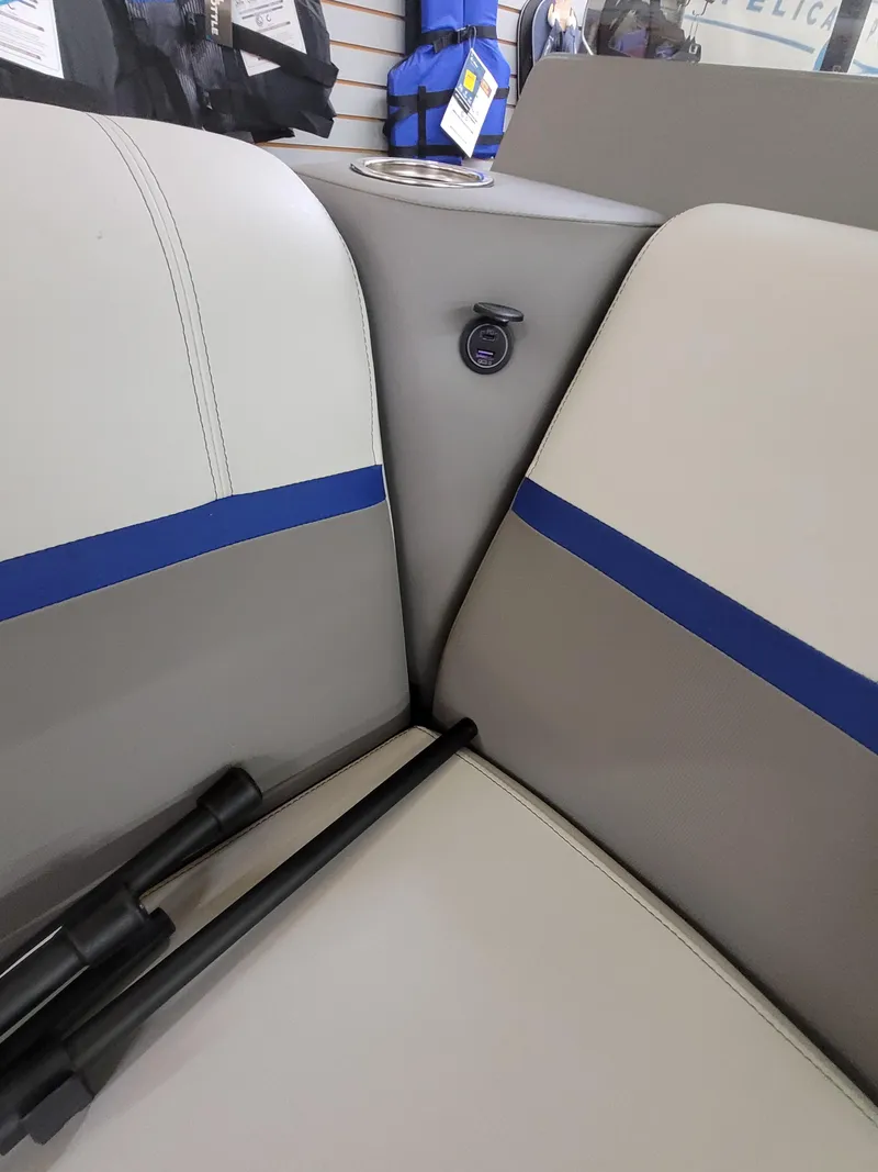 Slide: The Image of 2025 Quest 22 LE boat interior with beige and blue seating. - 18