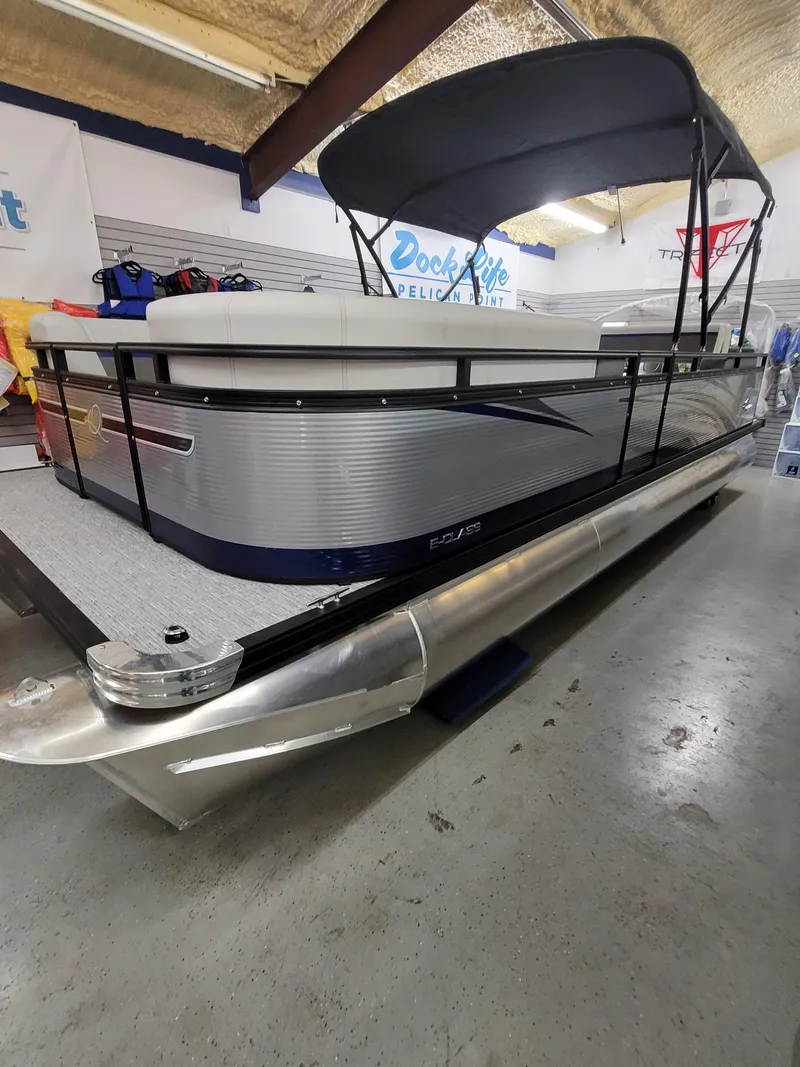 Slide: The Image of 2025 Quest 22 LE pontoon boat with canopy in showroom. - 2