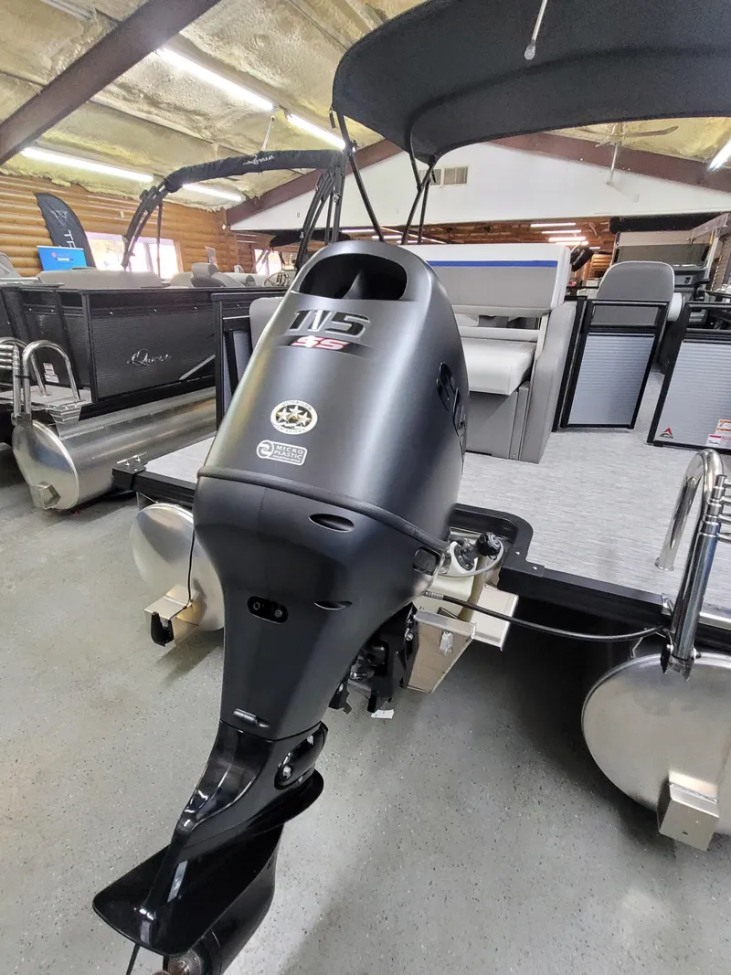 Slide: The Image of 2025 Quest 22 LE pontoon boat with powerful outboard motor in showroom. - 4