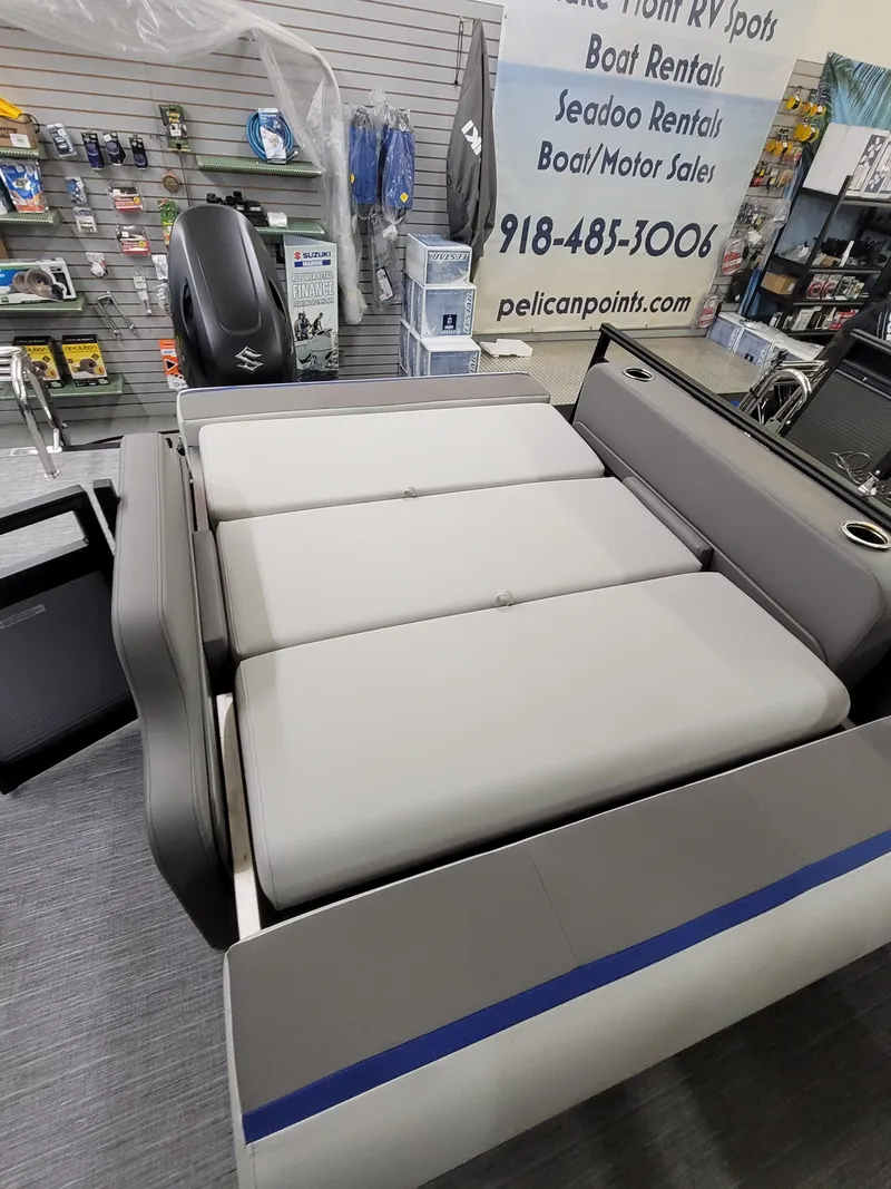 Slide: The Image of 2025 Quest 22 LE boat interior with cushioned seating in a showroom. - 7