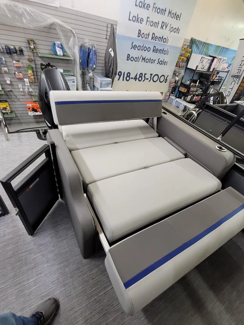 Slide: The Image of 2025 Quest 22 LE boat interior with gray seating and storage compartments. - 8