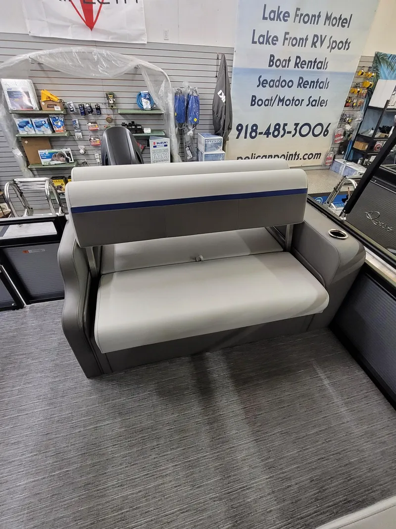 Slide: The Image of 2025 Quest 22 LE boat seat in showroom with accessories display. - 9