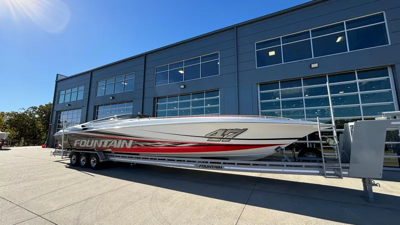 Slide: The Image of 2008 Fountain 47 Lightning boat on trailer outside a modern building. - 1