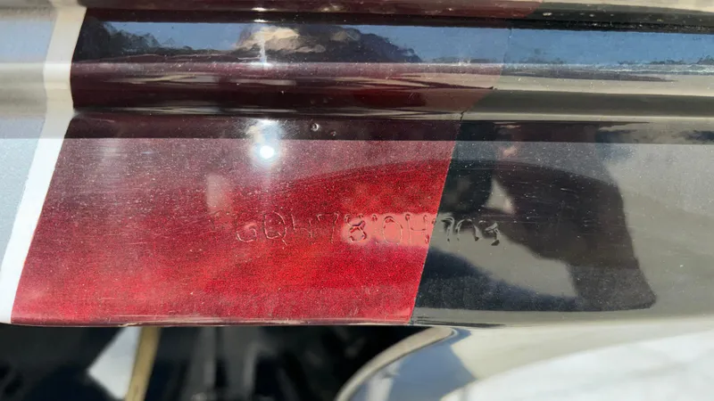 Slide: The Image of Close-up of a 2008 Fountain 47 Lightning boat hull with red and black detailing. - 13