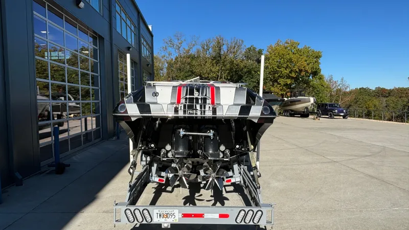 Slide: The Image of 2008 Fountain 47 Lightning boat on trailer, rear view, outdoors. - 2