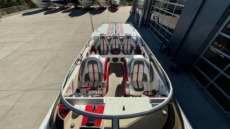 Slide: The Image of 2008 Fountain 47 Lightning boat with sleek seating and modern design in a marina setting. - 21