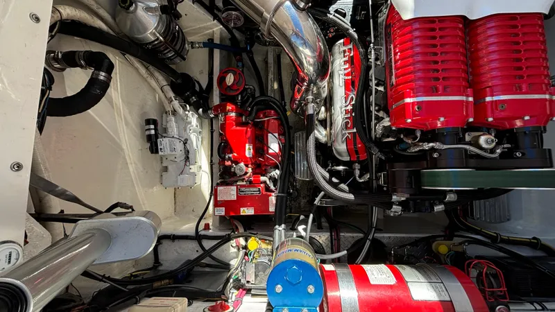 Slide: The Image of Engine compartment of a 2008 Fountain 47 Lightning boat, showcasing red and silver components. - 29