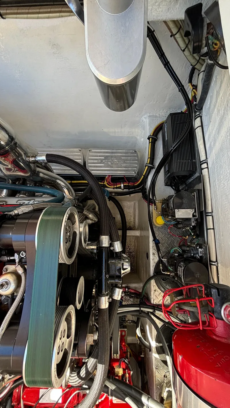Slide: The Image of Engine compartment of a 2008 Fountain 47 Lightning boat, showcasing mechanical components and wiring. - 30