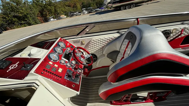 Slide: The Image of 2008 Fountain 47 Lightning boat cockpit with red and silver dashboard and seating. - 33