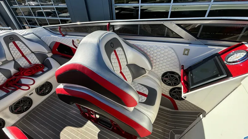 Slide: The Image of 2008 Fountain 47 Lightning boat interior with red and gray seating, dashboard, and speakers. - 38