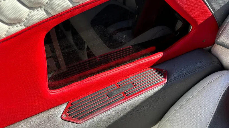 Slide: The Image of Interior detail of a 2008 Fountain 47 Lightning boat, featuring red and gray upholstery. - 44