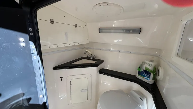 Slide: The Image of 2008 Fountain 47 Lightning boat bathroom with sink, toilet, and storage. - 48