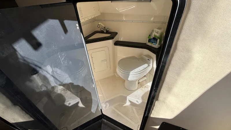 Slide: The Image of 2008 Fountain 47 Lightning boat bathroom interior with toilet and sink. - 49