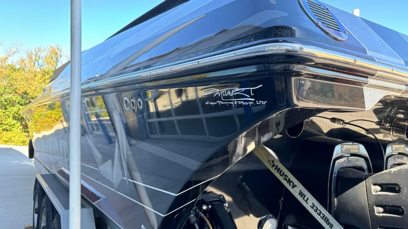 Slide: The Image of 2008 Fountain 47 Lightning boat, sleek black exterior, parked outdoors. - 9