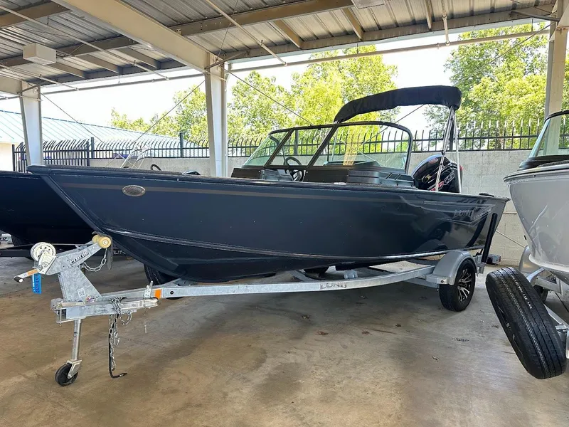 Slide: The Image of 2025 Lund 1775 Adventure Sport boat on trailer in covered storage area. - 0