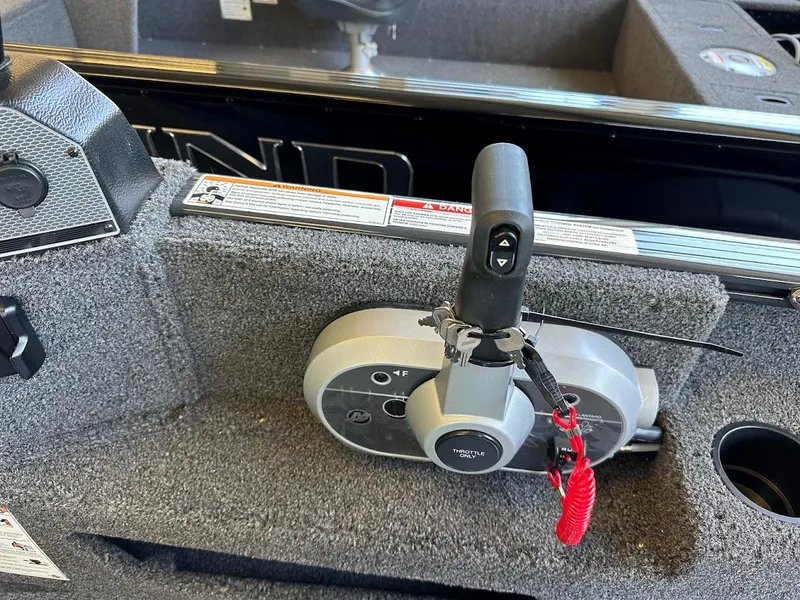 Slide: The Image of Control panel of 2025 Lund 1775 Adventure Sport boat with throttle and safety lanyard. - 11