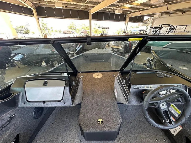 Slide: The Image of 2025 Lund 1775 Adventure Sport boat interior with steering wheel and dashboard. - 12