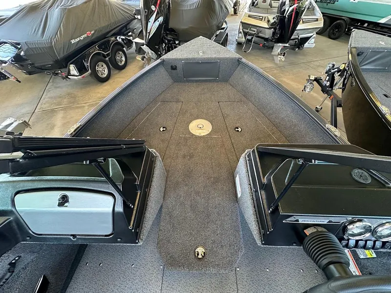 Slide: The Image of 2025 Lund 1775 Adventure Sport boat interior with covered boats in the background. - 13