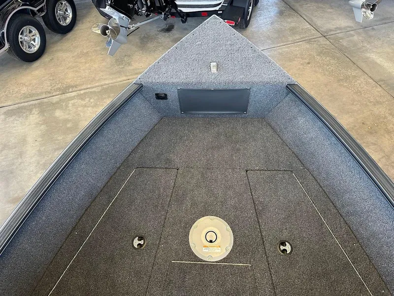 Slide: The Image of 2025 Lund 1775 Adventure Sport boat interior with carpeted deck and storage compartments. - 14