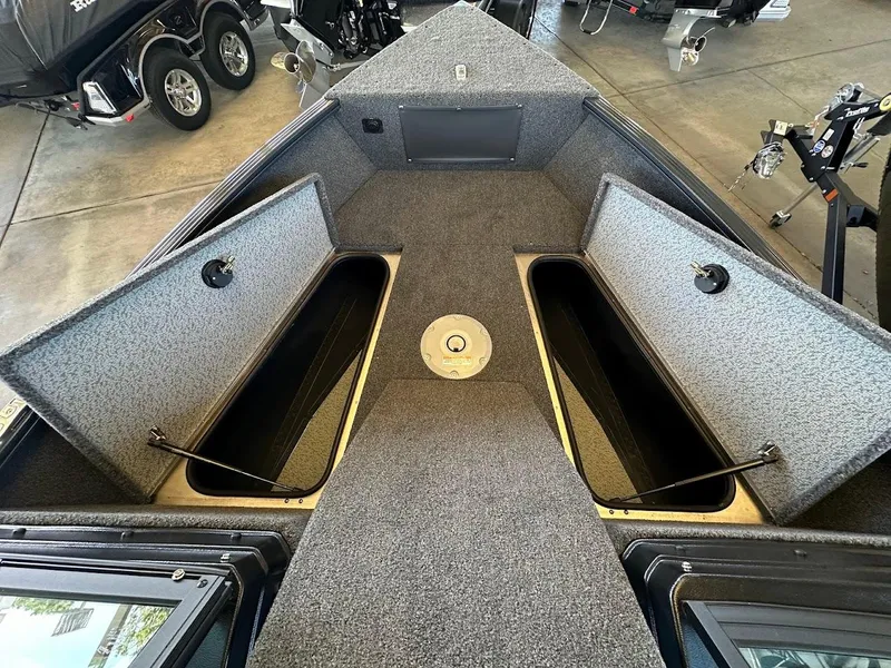 Slide: The Image of 2025 Lund 1775 Adventure Sport boat interior with open storage compartments. - 16