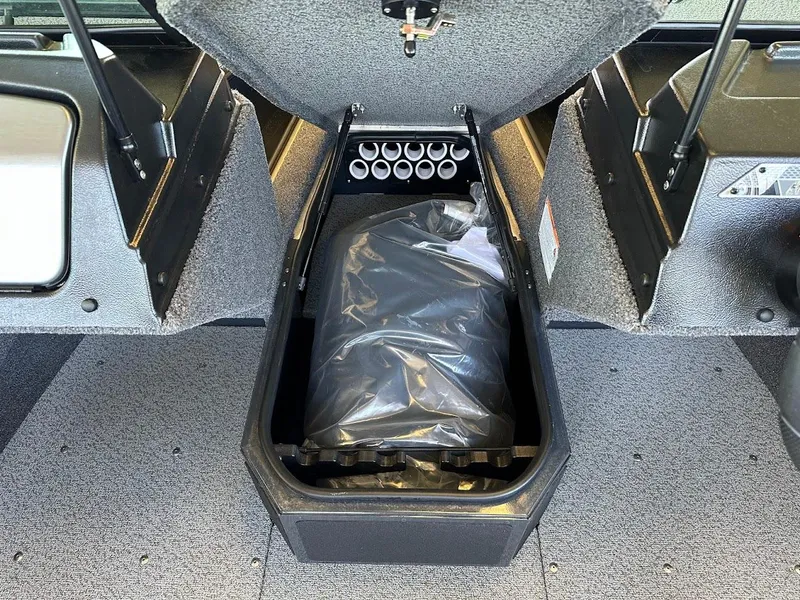 Slide: The Image of 2025 Lund 1775 Adventure Sport storage compartment with organized interior and protective cover. - 17