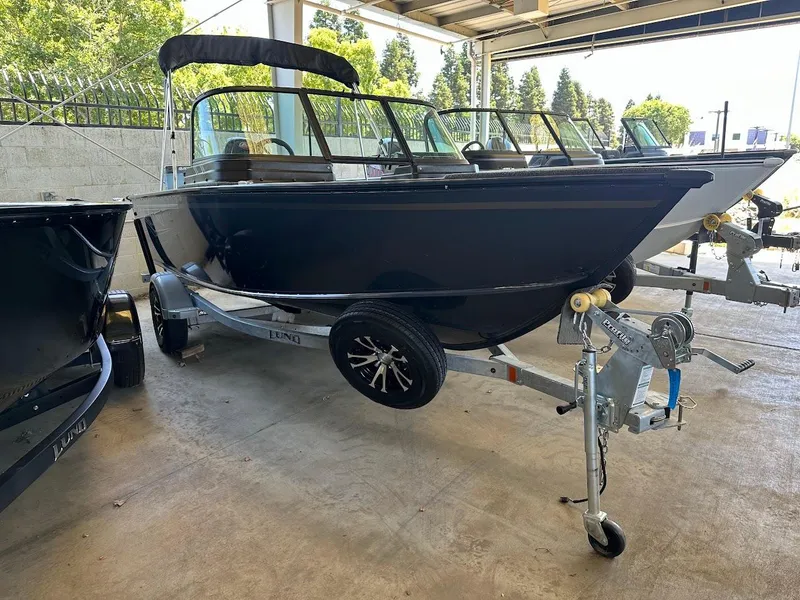 Slide: The Image of 2025 Lund 1775 Adventure Sport boat on trailer in covered storage area. - 2