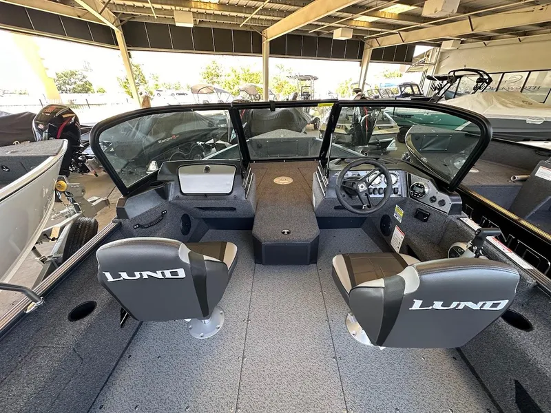 Slide: The Image of 2025 Lund 1775 Adventure Sport boat interior with dual seats and steering console. - 5