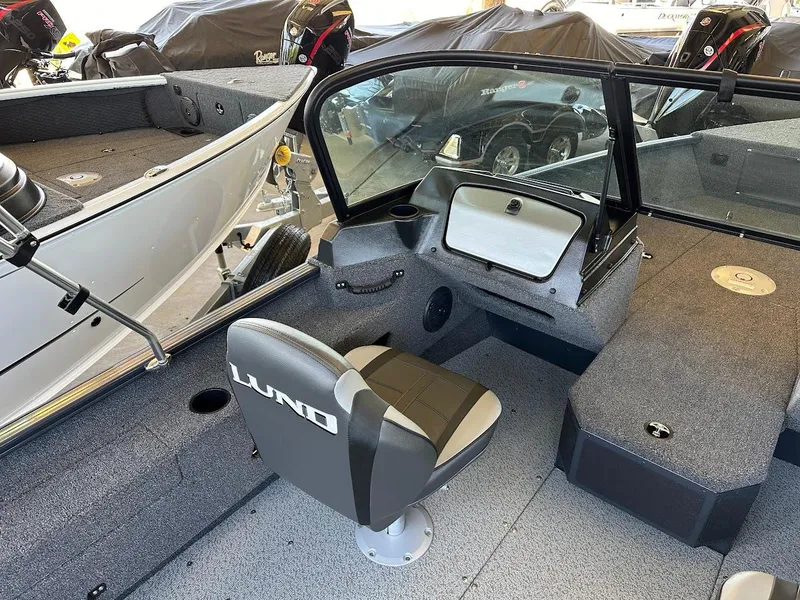 Slide: The Image of 2025 Lund 1775 Adventure Sport boat interior with seating and dashboard view. - 6