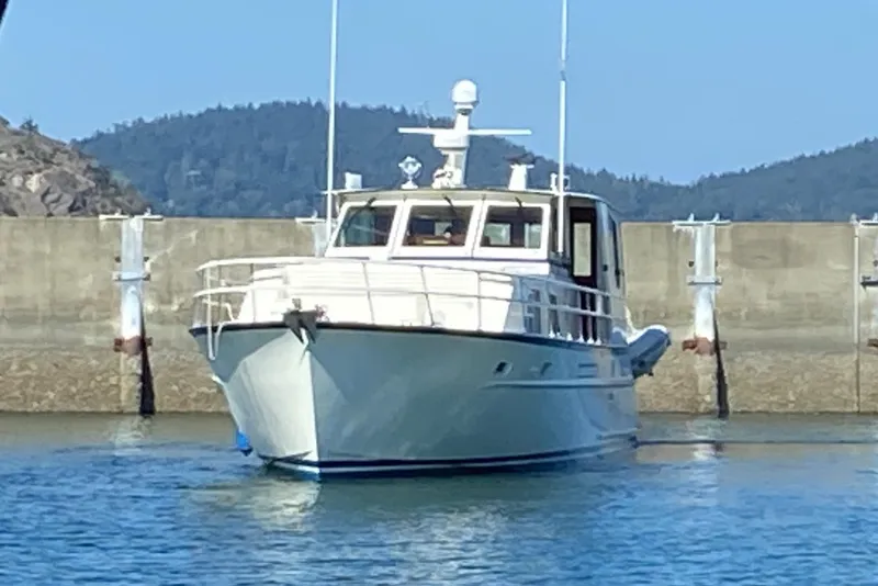 Slide: The Image of 1971 Matthews Custom Pilothouse Motor Yacht docked in a serene harbor. - 1