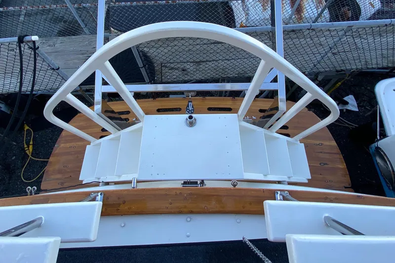 Slide: The Image of 1971 Matthews Custom Pilothouse Motor Yacht deck with white railing and wooden flooring. - 10