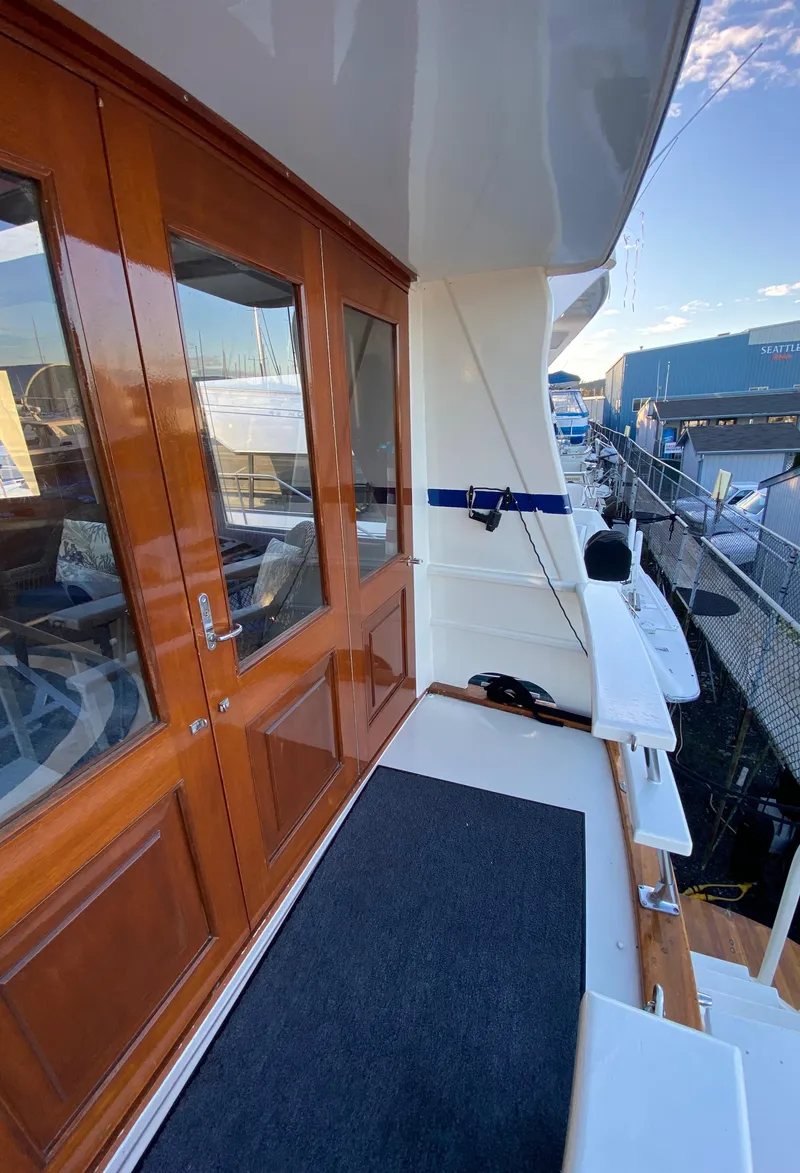 Slide: The Image of 1971 Matthews Custom Pilothouse Motor Yacht with wooden doors and deck view. - 12