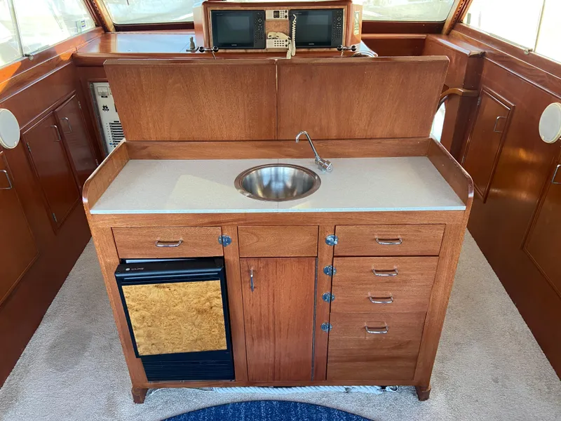 Slide: The Image of 1971 Matthews Custom Pilothouse Motor Yacht interior with wooden cabinetry and sink. - 17