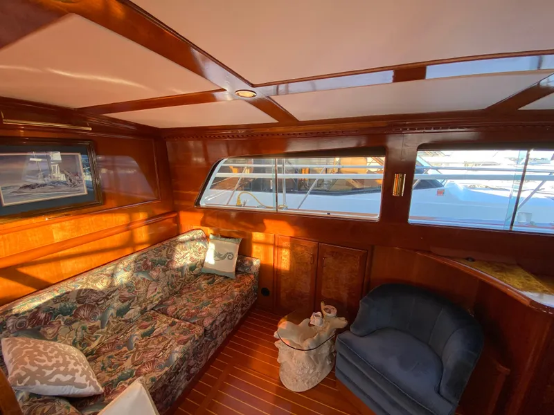 Slide: The Image of Interior of 1971 Matthews Custom Pilothouse Motor Yacht with wood paneling and cozy seating. - 23