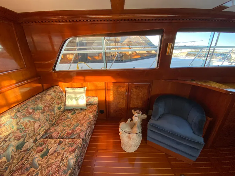 Slide: The Image of 1971 Matthews Custom Pilothouse Motor Yacht interior with floral sofa and blue armchair. - 24