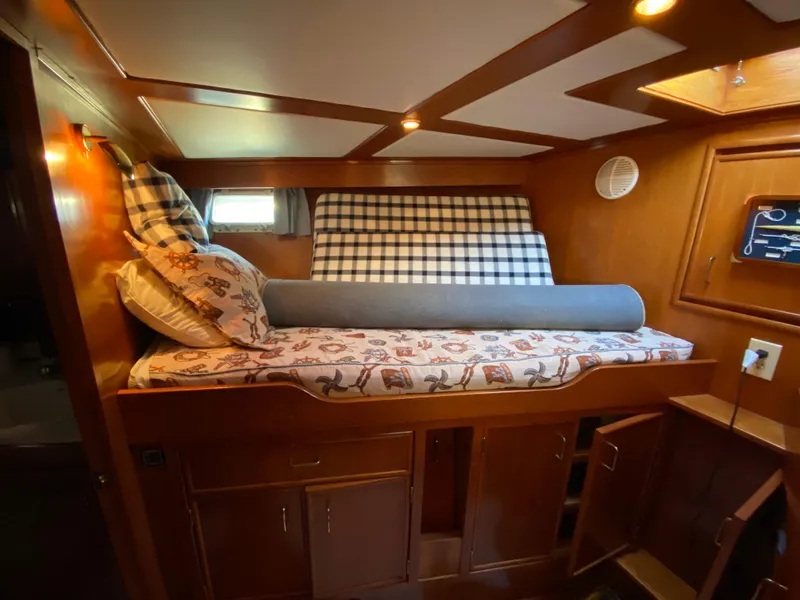 Slide: The Image of Cozy cabin interior of 1971 Matthews Custom Pilothouse Motor Yacht with wooden finish and bedding. - 28