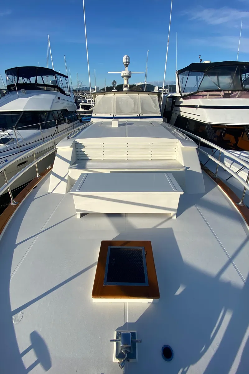 Slide: The Image of 1971 Matthews Custom Pilothouse Motor Yacht docked, showcasing spacious deck and sleek design. - 3