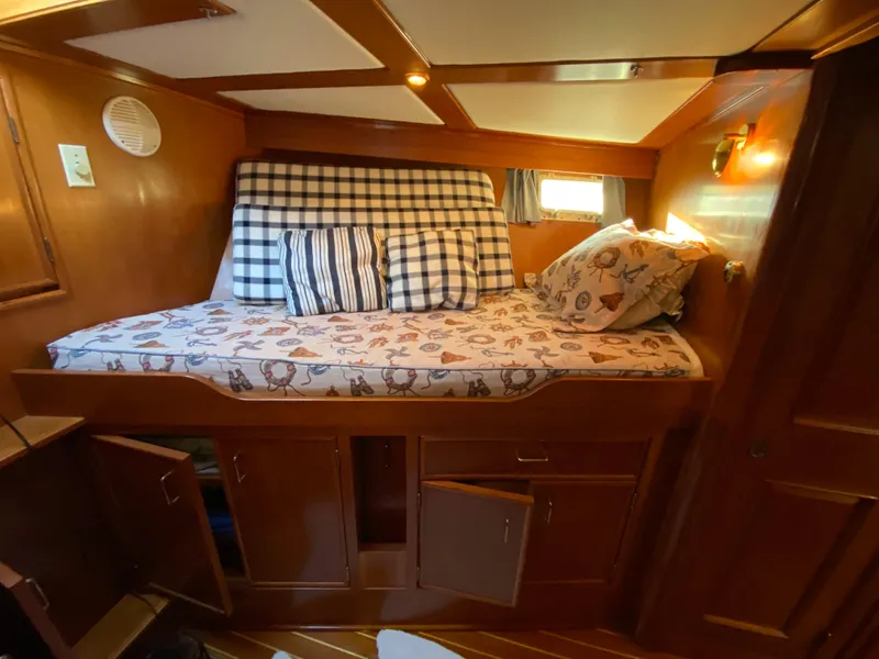 Slide: The Image of Cozy cabin interior of 1971 Matthews Custom Pilothouse Motor Yacht with patterned bedding. - 30