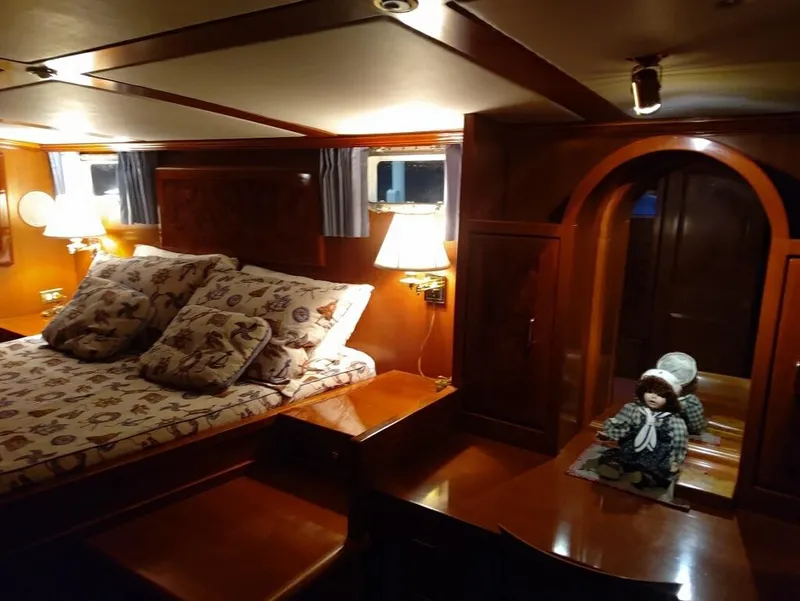 Slide: The Image of Luxurious 1971 Matthews Custom Pilothouse Motor Yacht bedroom with elegant wood finish and cozy lighting. - 32