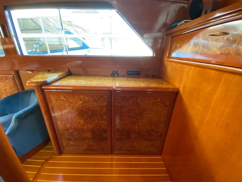 Slide: The Image of 1971 Matthews Custom Pilothouse Motor Yacht interior with wood cabinetry and seating. - 38