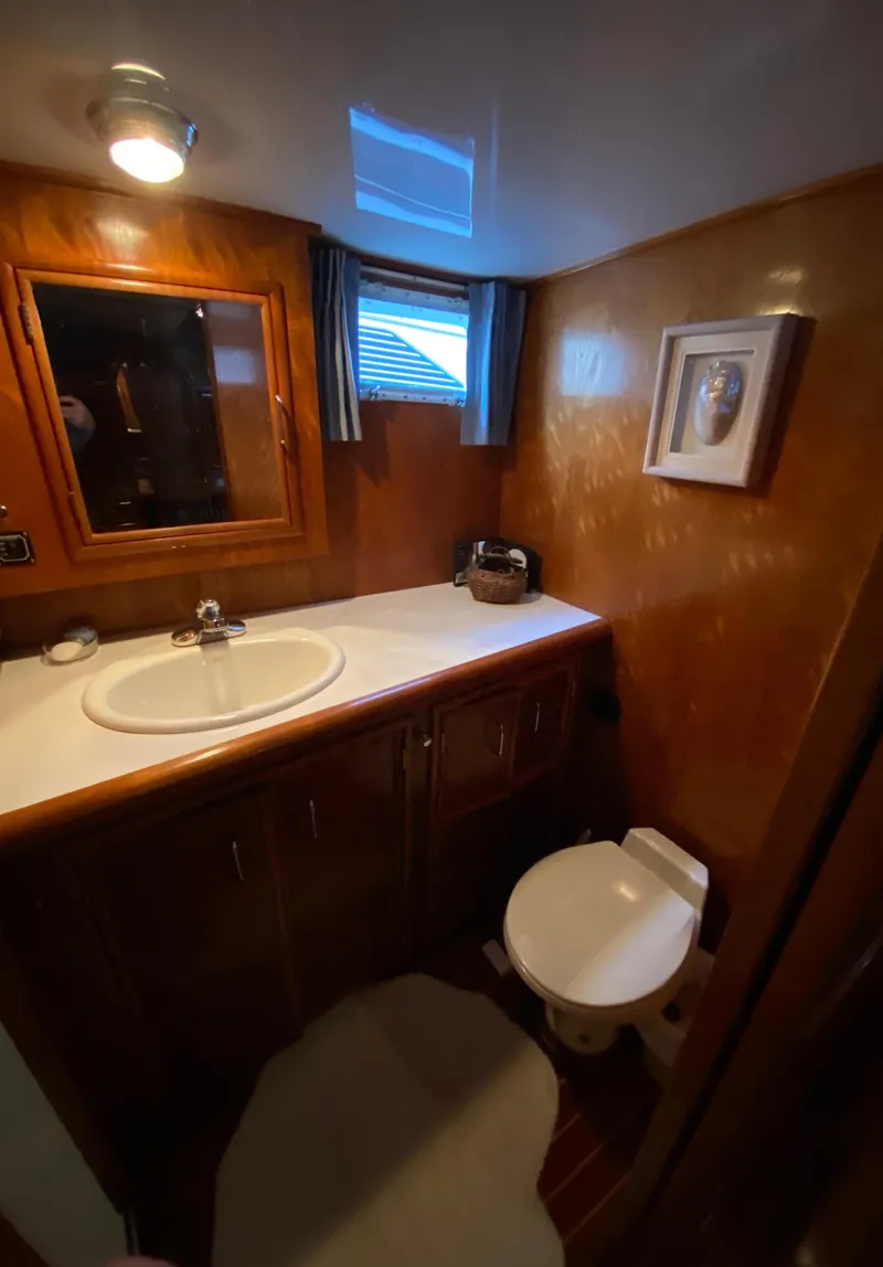 Slide: The Image of 1971 Matthews Custom Pilothouse Motor Yacht bathroom with wooden cabinetry and modern fixtures. - 41