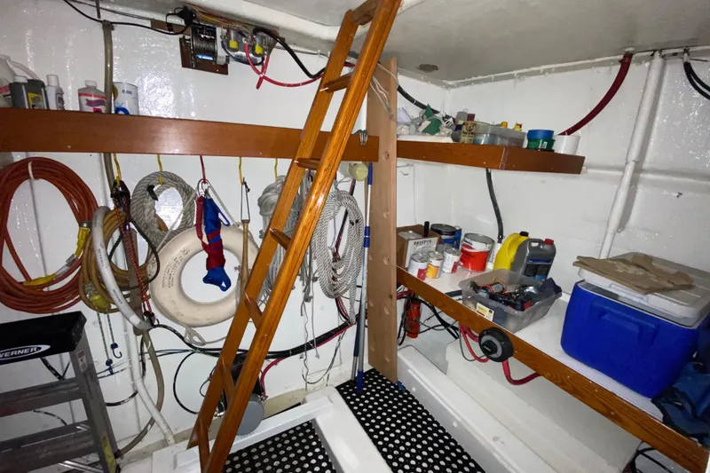 Slide: The Image of 1971 Matthews Custom Pilothouse Motor Yacht interior with ladder, ropes, and storage shelves. - 43