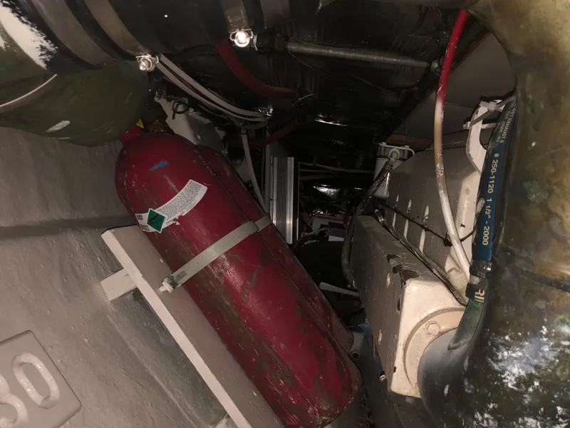 Slide: The Image of Engine room of 1971 Matthews Custom Pilothouse Motor Yacht with red cylinder and piping. - 46