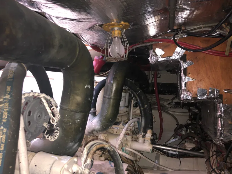 Slide: The Image of Engine room of a 1971 Matthews Custom Pilothouse Motor Yacht with visible pipes and wiring. - 47